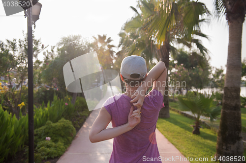 Image of woman  stretching before morning jogging