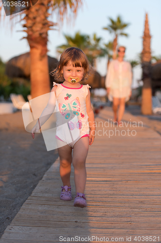 Image of girl and mother walking