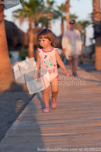 Image of girl and mother walking
