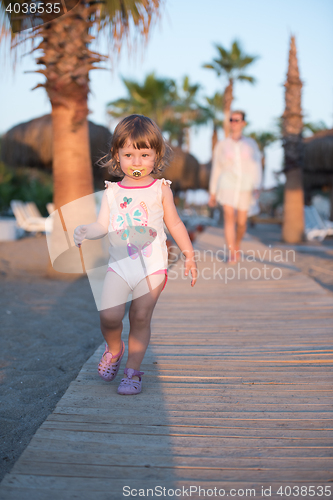 Image of girl and mother walking