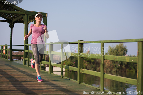 Image of sporty woman jogging