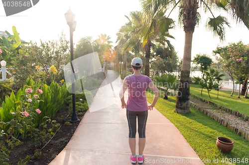 Image of woman  stretching before morning jogging