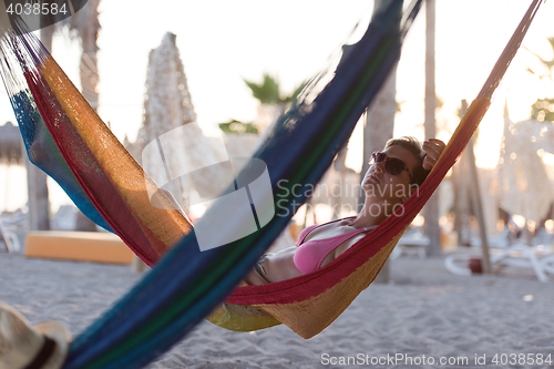 Image of relaxed woman laying in hammock