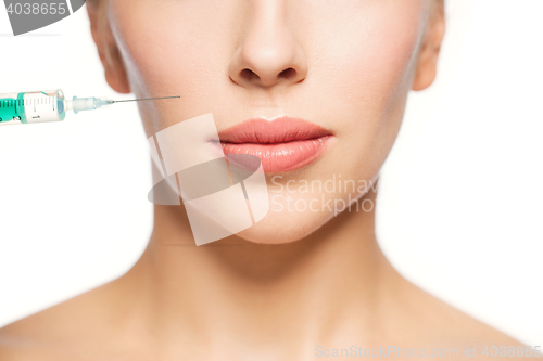 Image of woman face and syringe making injection