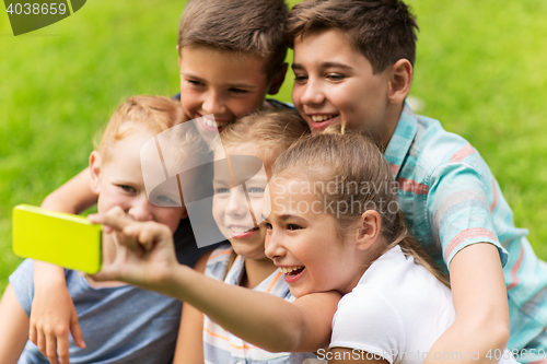 Image of happy kids or friends taking selfie in summer park