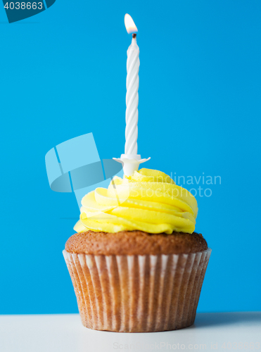 Image of birthday cupcake with one burning candle