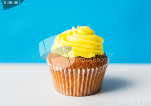 Image of close up of cupcake or muffin with icing on table