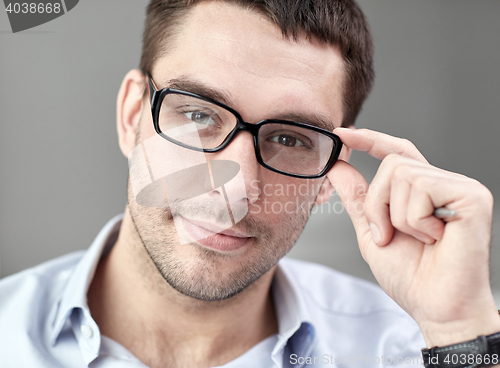 Image of portrait of businessman in eyeglasses at office