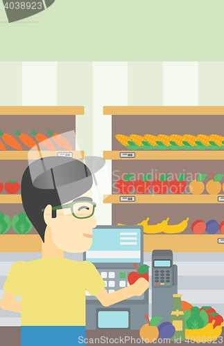 Image of Cashier standing at the checkout in supermarket.