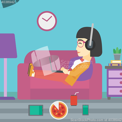 Image of Woman lying on sofa with many gadgets.