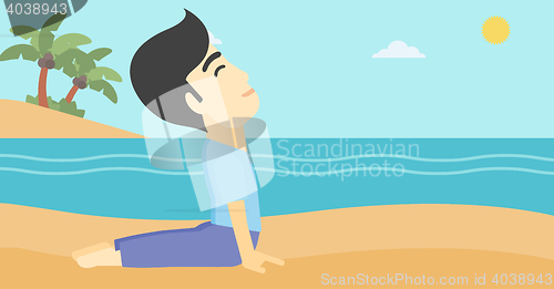 Image of Man practicing yoga upward dog pose on the beach.