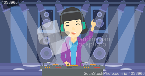 Image of Smiling DJ mixing music on turntables.