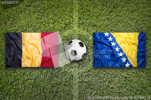 Image of Belgium and Bosnia and Herzegovina flags on soccer field