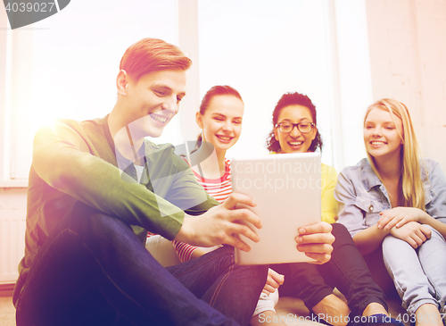 Image of smiling students making picture with tablet pc