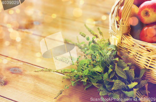 Image of close up of melissa and basket with apples