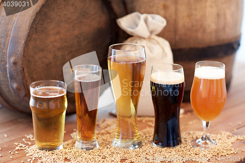 Image of close up of beer barrel, glasses and bag with malt