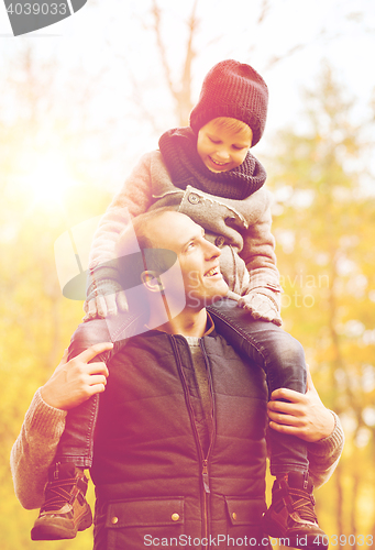 Image of happy family having fun in autumn park