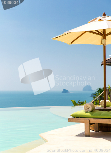 Image of view from infinity edge pool with parasol to sea