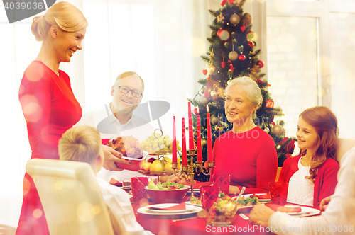 Image of smiling family having holiday dinner at home