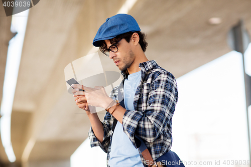 Image of hipster man texting message on smartphone