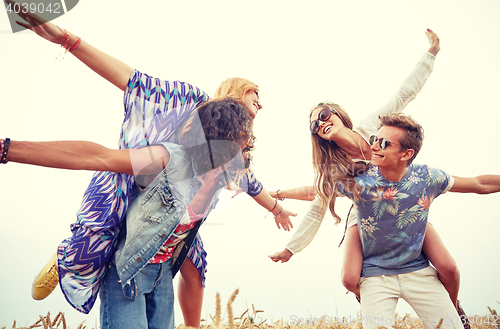 Image of happy hippie friends having fun on cereal field