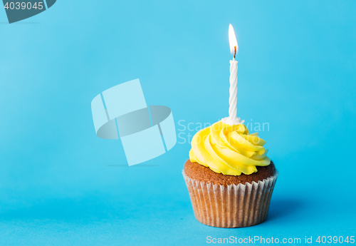 Image of birthday cupcake with one burning candle