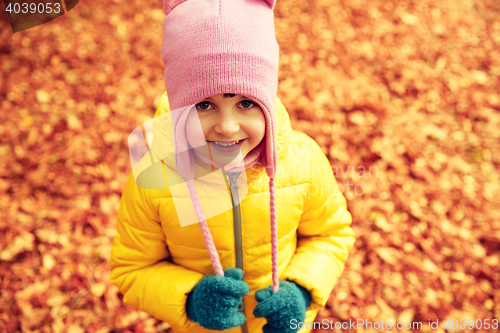 Image of happy little girl in autumn park