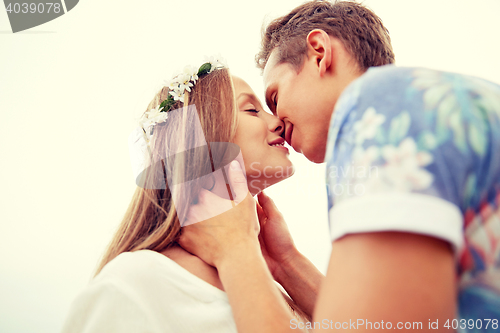 Image of happy smiling young hippie couple kissing outdoors