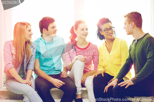 Image of five smiling teenagers having fun at home