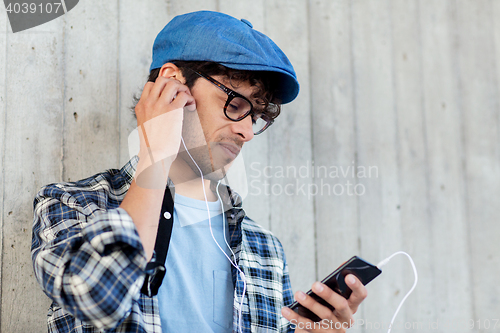 Image of man with earphones and smartphone listening music