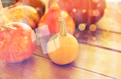 Image of close up of pumpkins on wooden table at home