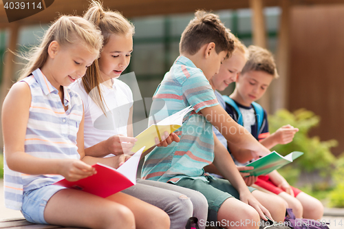 Image of group of happy elementary school students outdoors