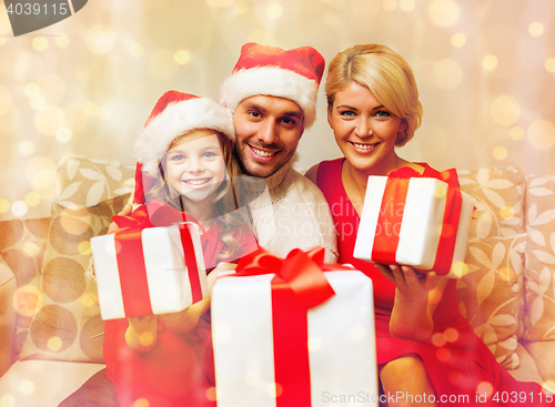 Image of smiling family giving many gift boxes