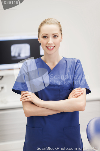 Image of happy female dentist at dental clinic office