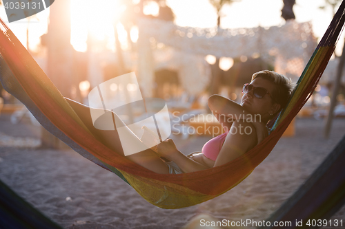 Image of relaxed woman laying in hammock