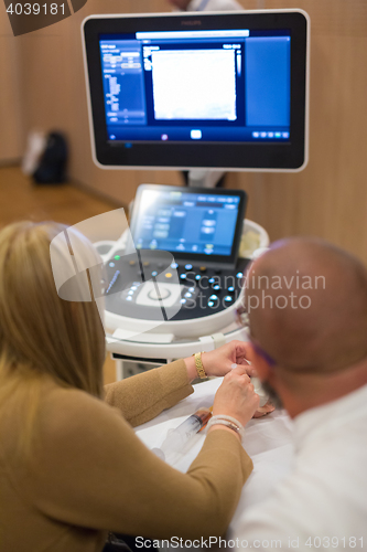 Image of Medical doctor student learning to use ultra sound scanner machine.