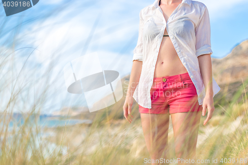 Image of Relaxed woman in white shirt enjoying in nature.