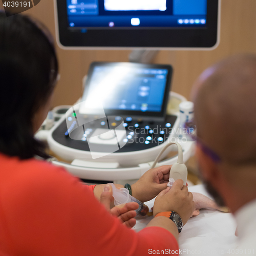 Image of Medical doctor student learning to use ultra sound scanner machine.