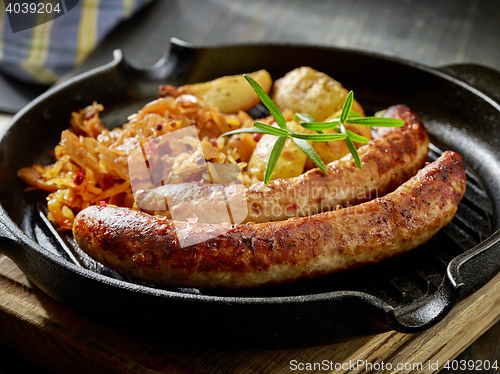 Image of grilled sausages and vegetables on cooking pan