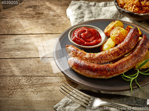 Image of grilled sausages on dark plate