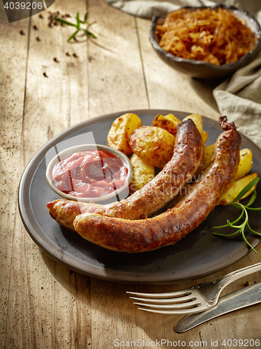 Image of grilled sausages on dark plate