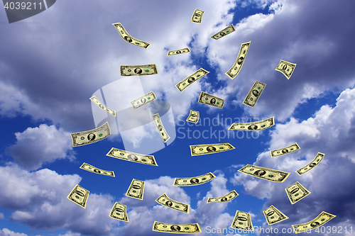 Image of dollar banknotes flying away in the sky