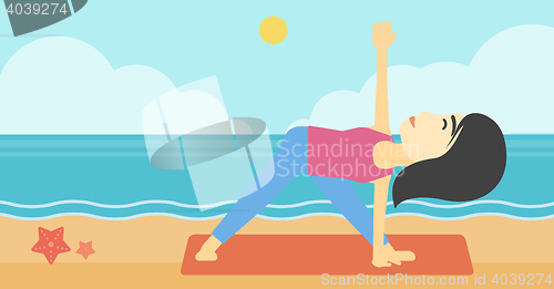 Image of Woman practicing yoga triangle pose on the beach.