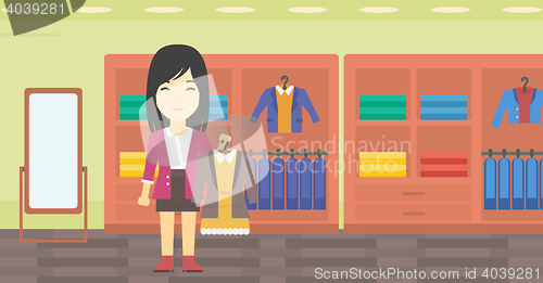 Image of Woman holding dress with jacket.