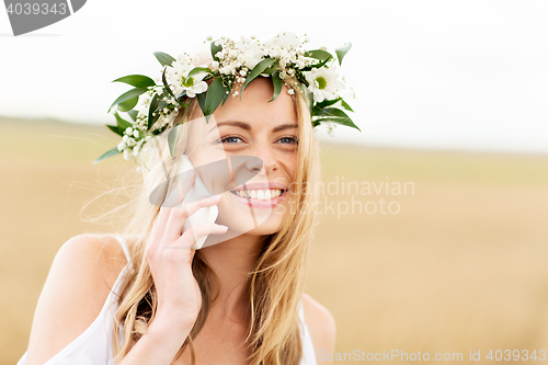 Image of happy young woman calling on smartphone at country