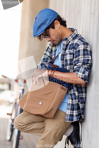 Image of hipster man with shoulder bag and fixed gear bike