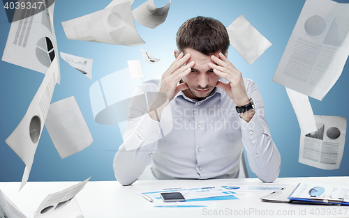 Image of close up of businessman with smartphone and papers