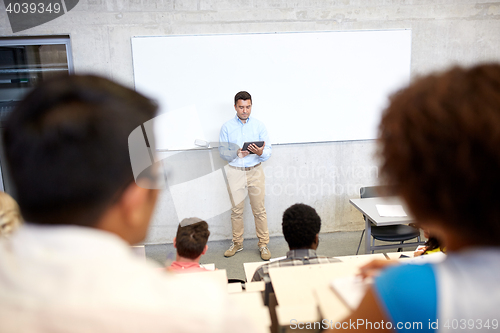 Image of students and teacher with tablet pc at lecture