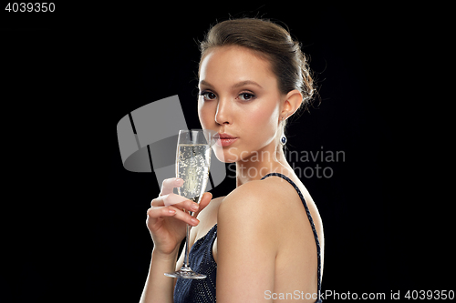 Image of young asian woman drinking champagne at party