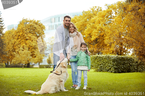 Image of happy family with labrador retriever dog in park
